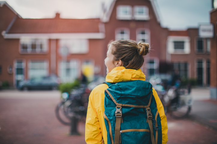 smiling student walking at the street